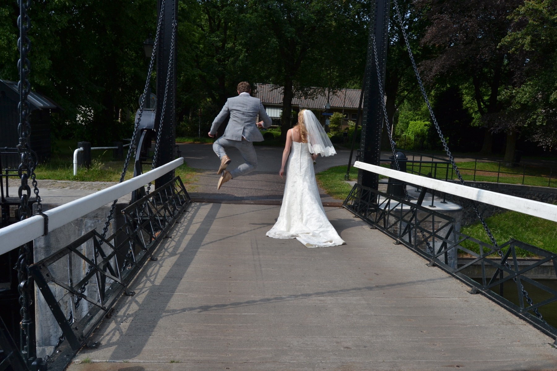 Wedding couple crossing bridge